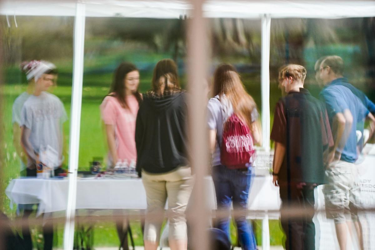 students standing at a table outside